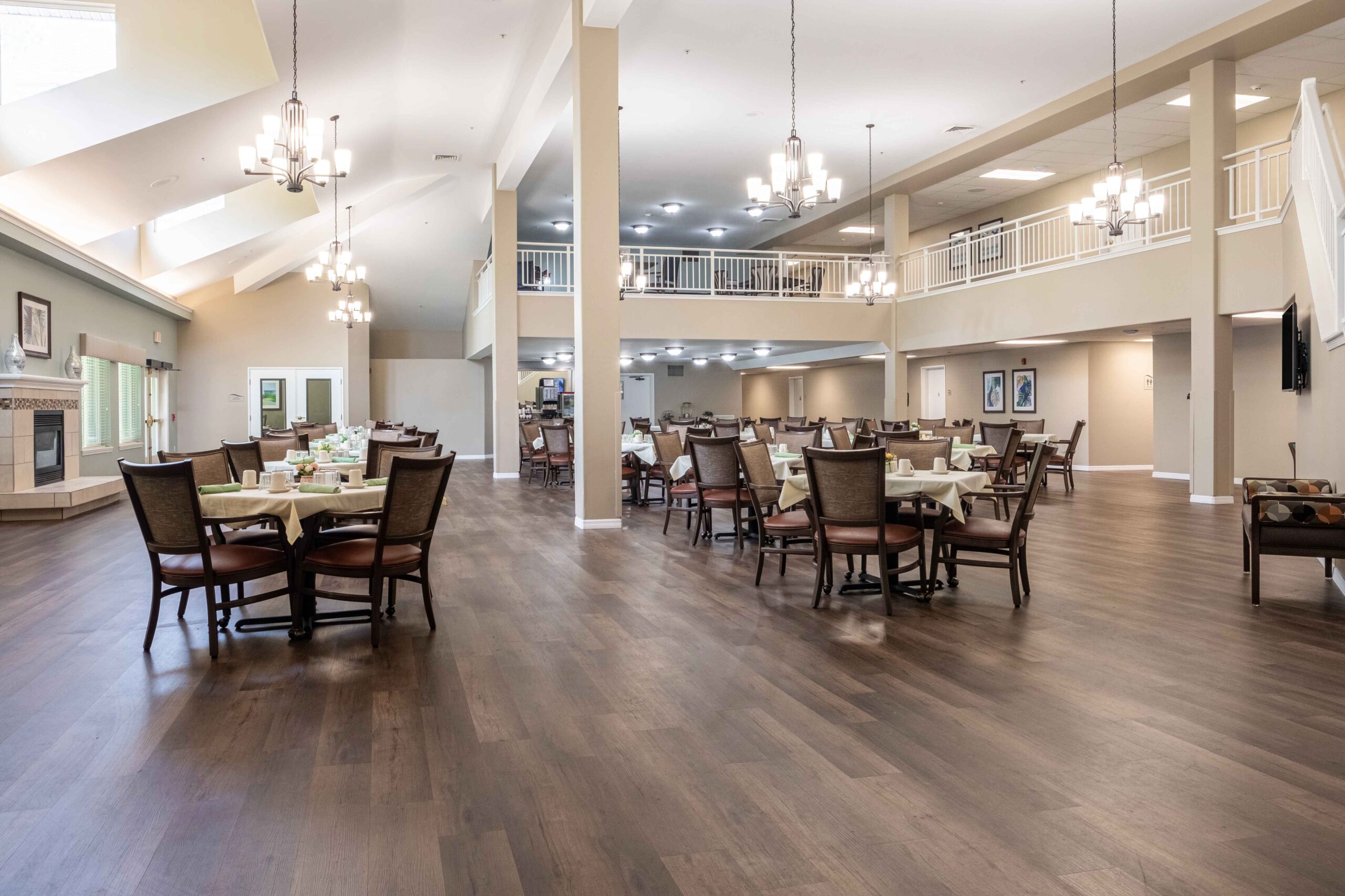 View of the grand dining hall from the second floor at Augustine Landing, a senior independent living community in Florida.