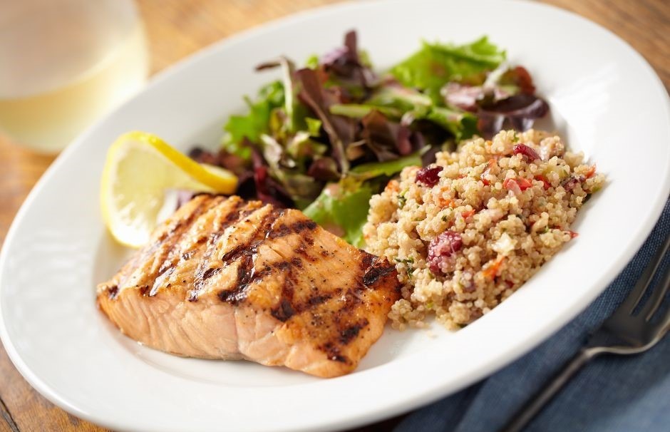 Plated meal with salmon, salad, and rice