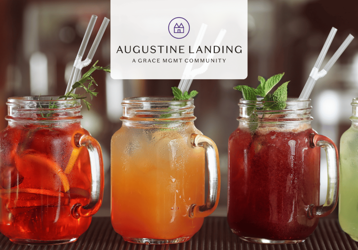 Row of colorful mason jar drinks with mint garnish and straws on a bar, overlaid with Augustine Landing logo.